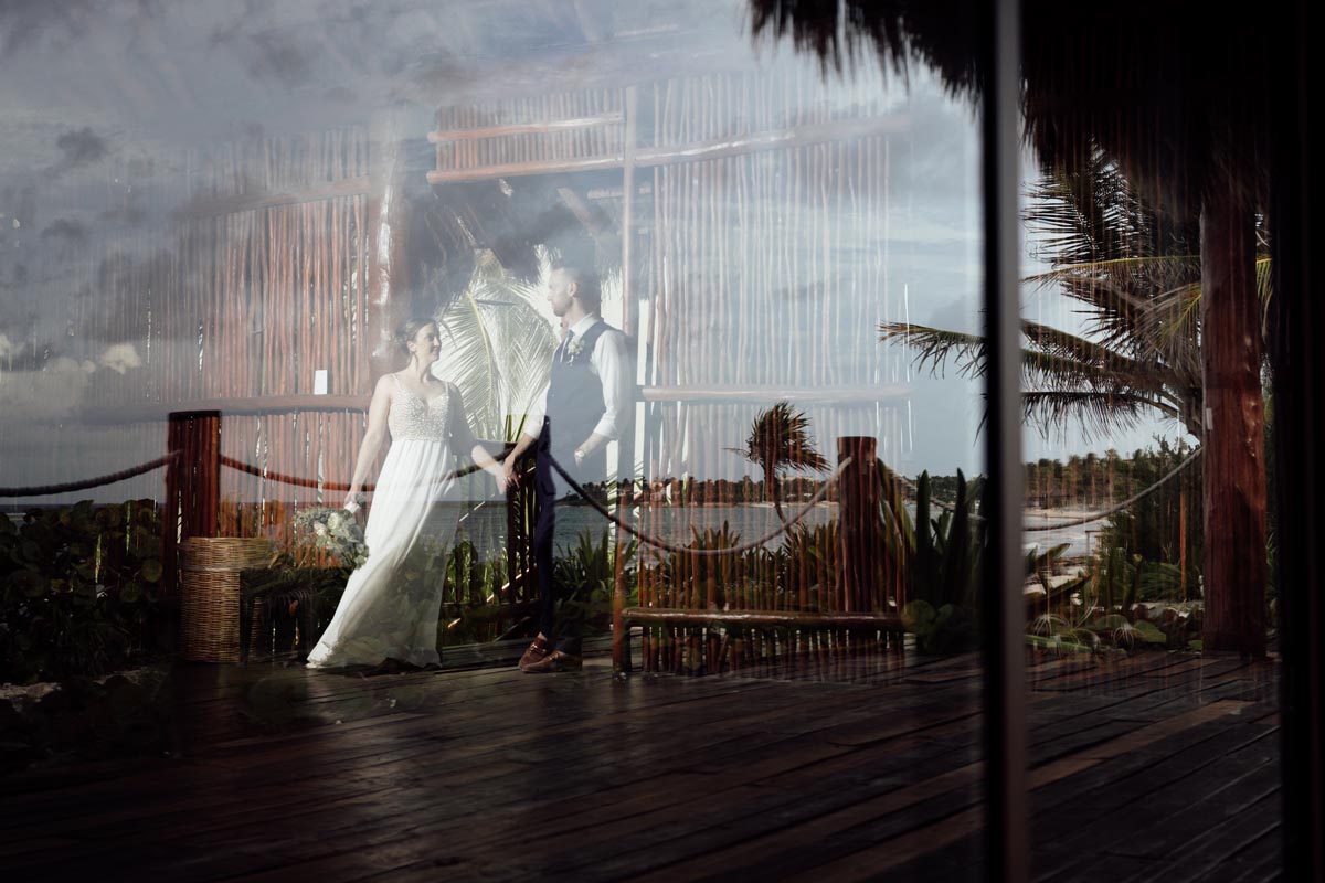 Ethereal image of newlyweds superimposed on overwater deck