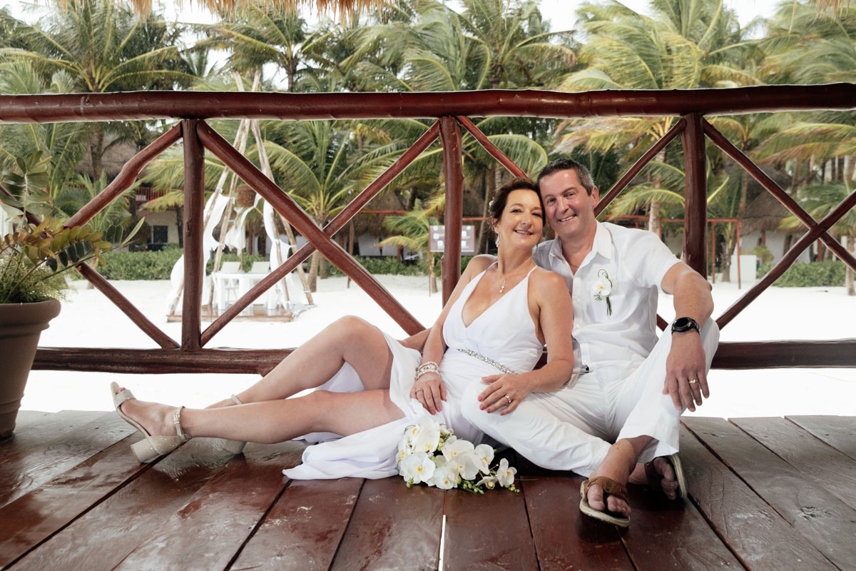 Vows Renewal couple snuggle on overwater deck