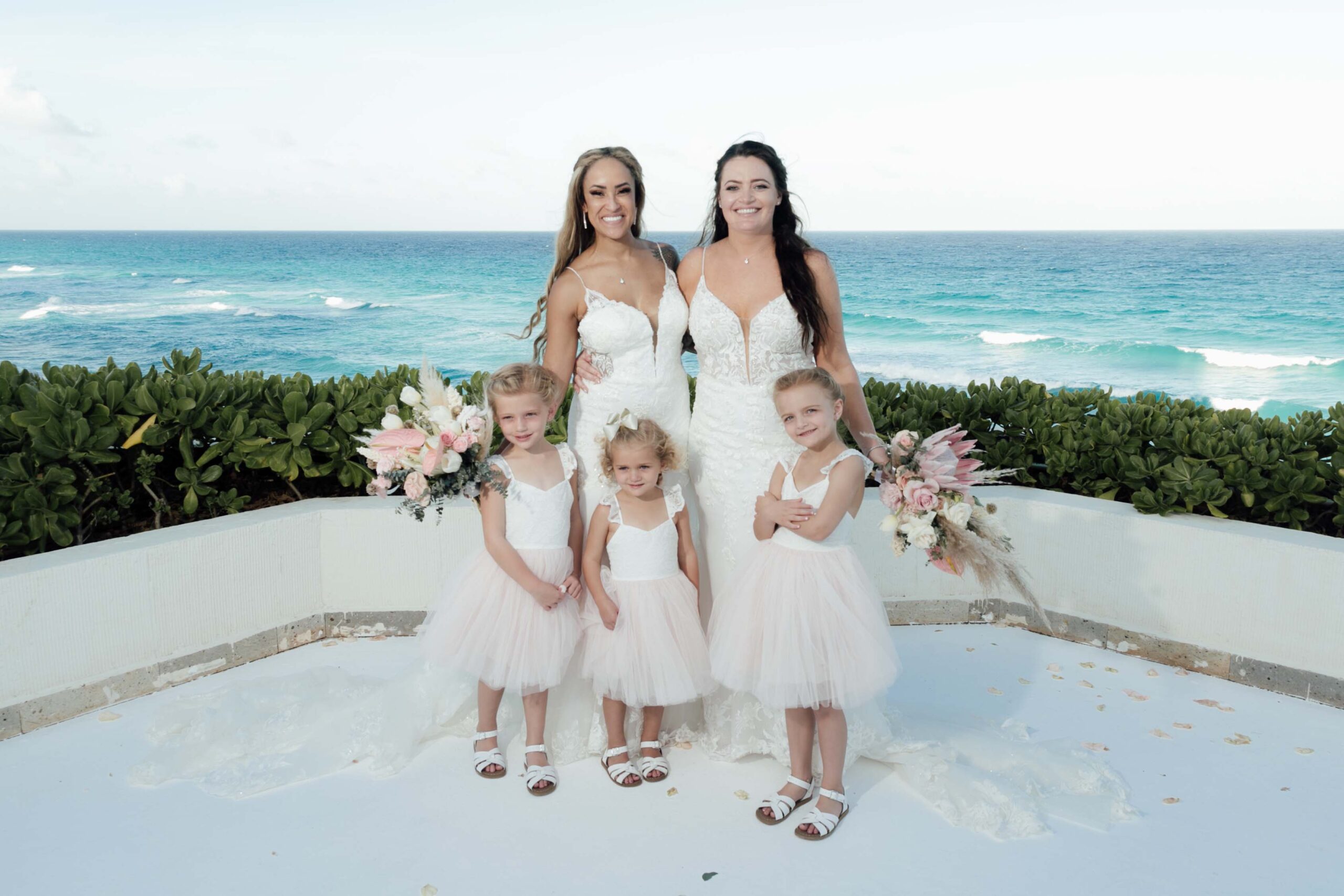 Newlyweds pose with 3 precious flower girls