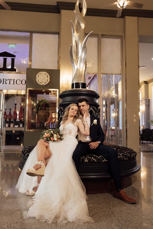 Newlyweds pose in lobby of regal Riu Palace