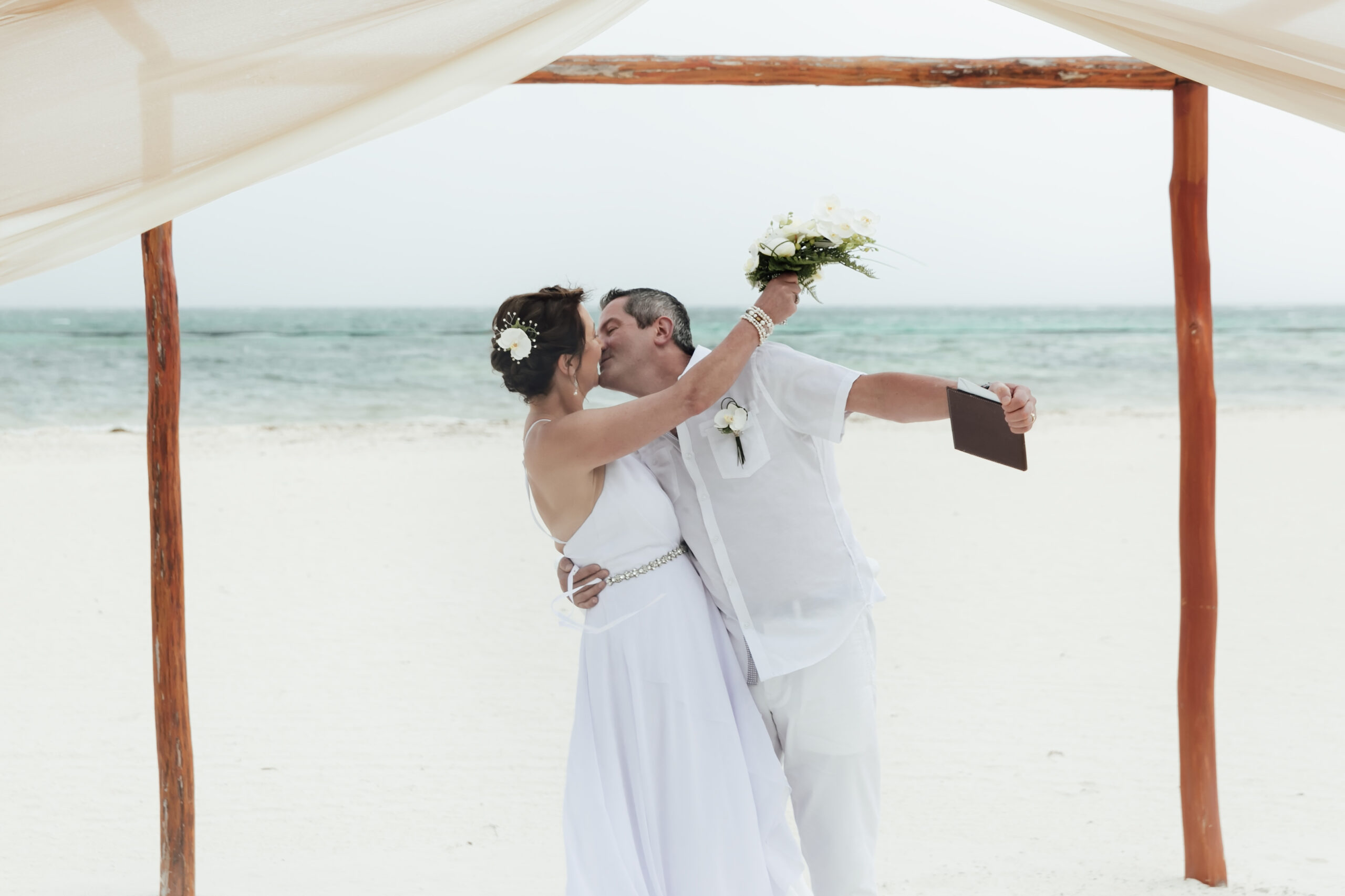 Happy couple renew vows on the beach