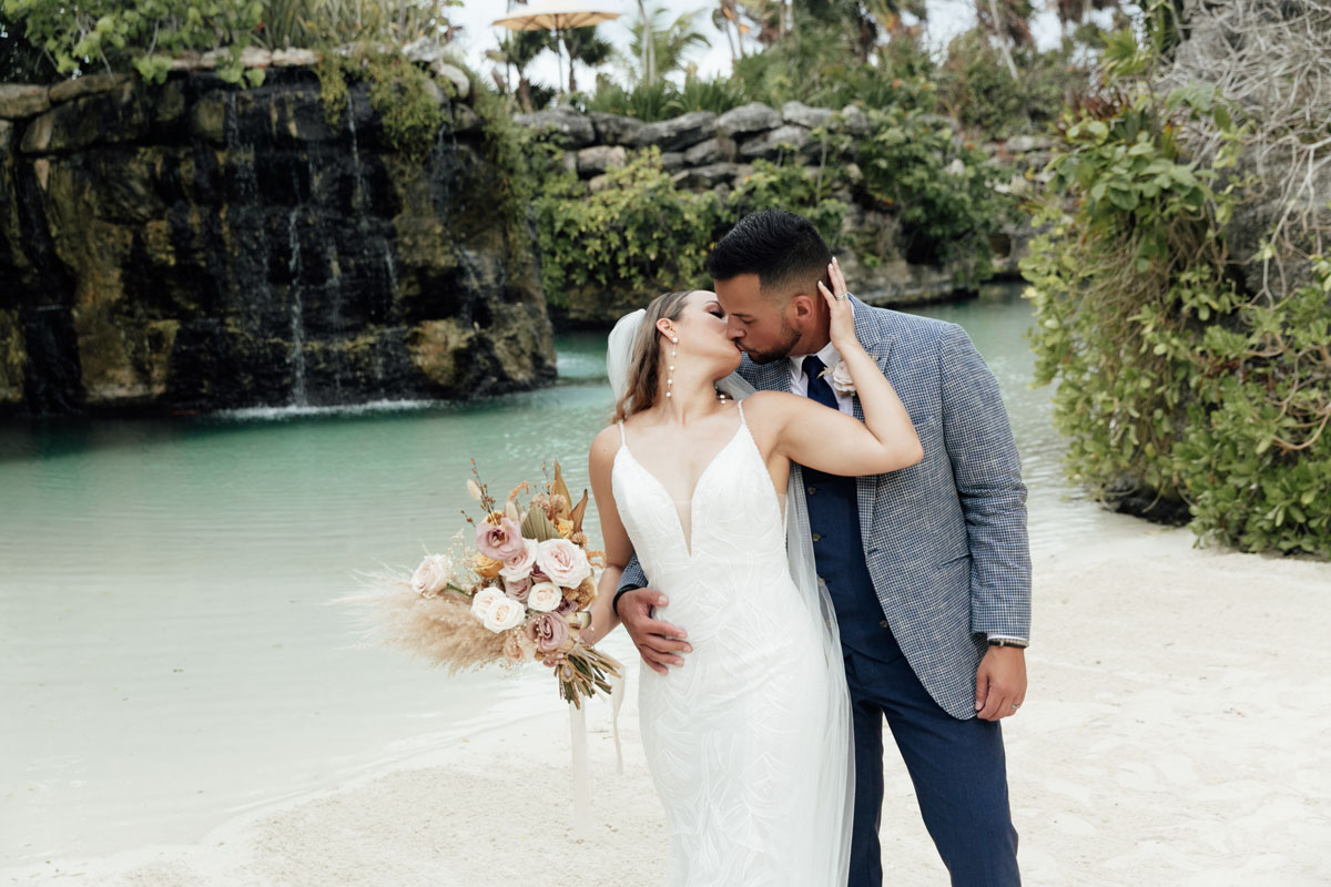 Newlyweds kiss in Xcaret waterpark