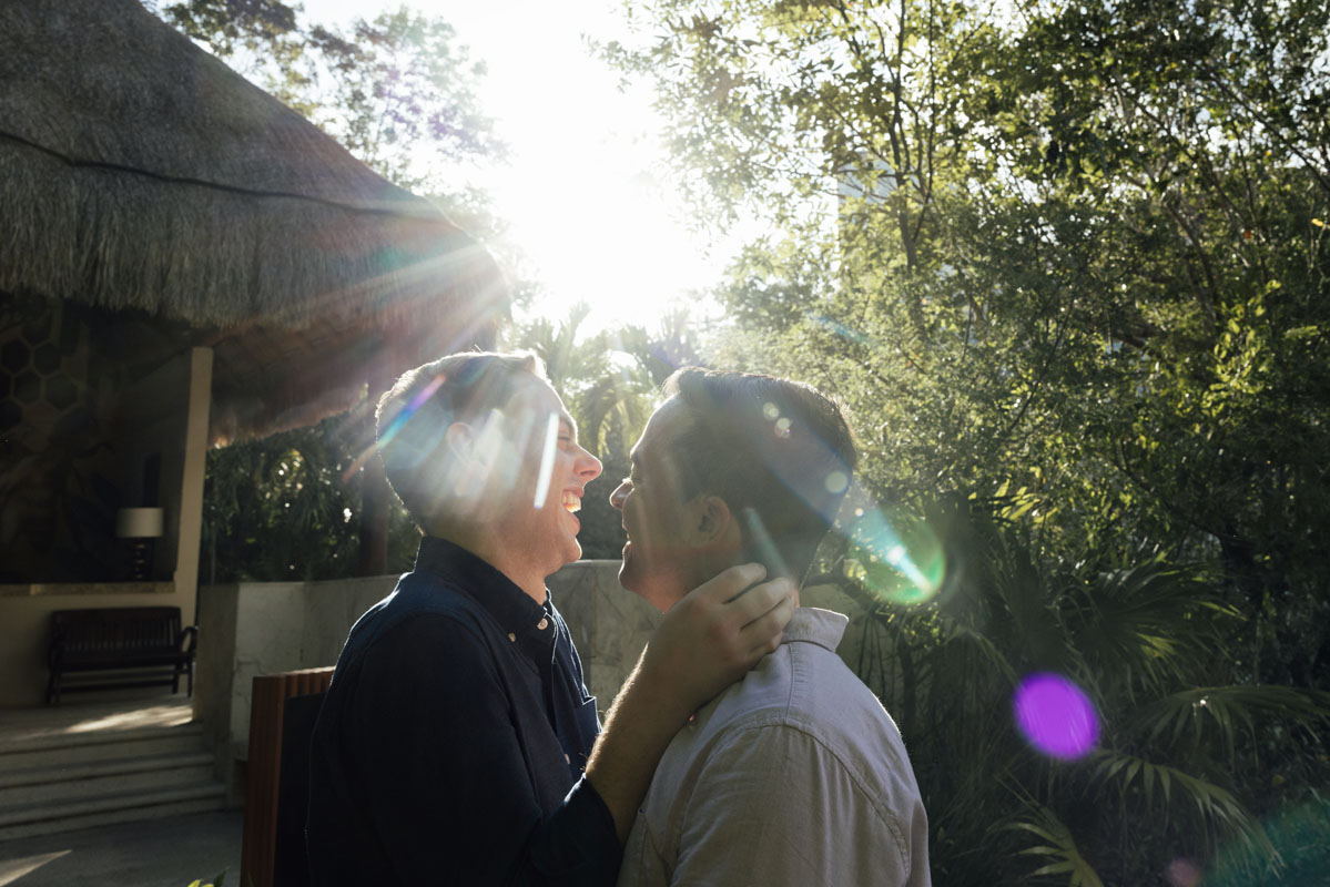 Laughing couple embraces in a setting sunbeam