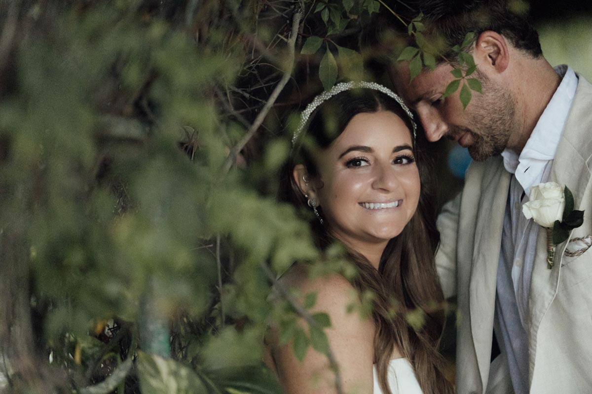 Newlyweds snuggle, embraced by the verdant jungle