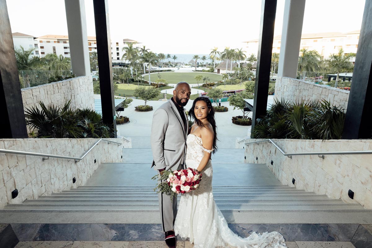 Newlyweds pause on the steps of Dreams Playa Mujeres