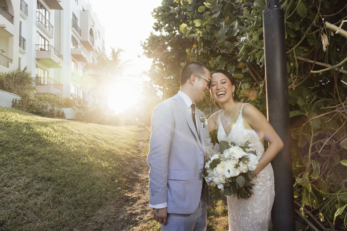 Newlyweds kiss as sun sets over the gardens