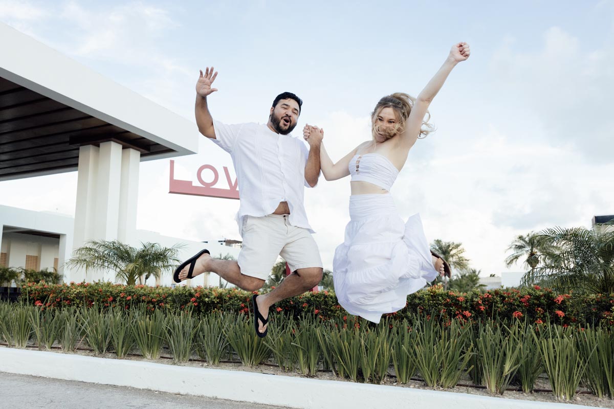 Happy couple jumps for joy at being engaged