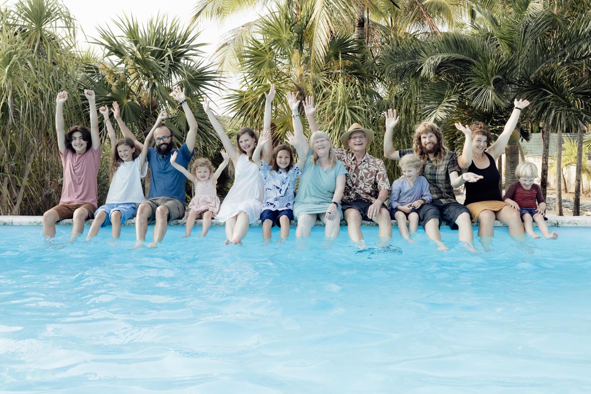 Cheering family dangles their feet in the pool