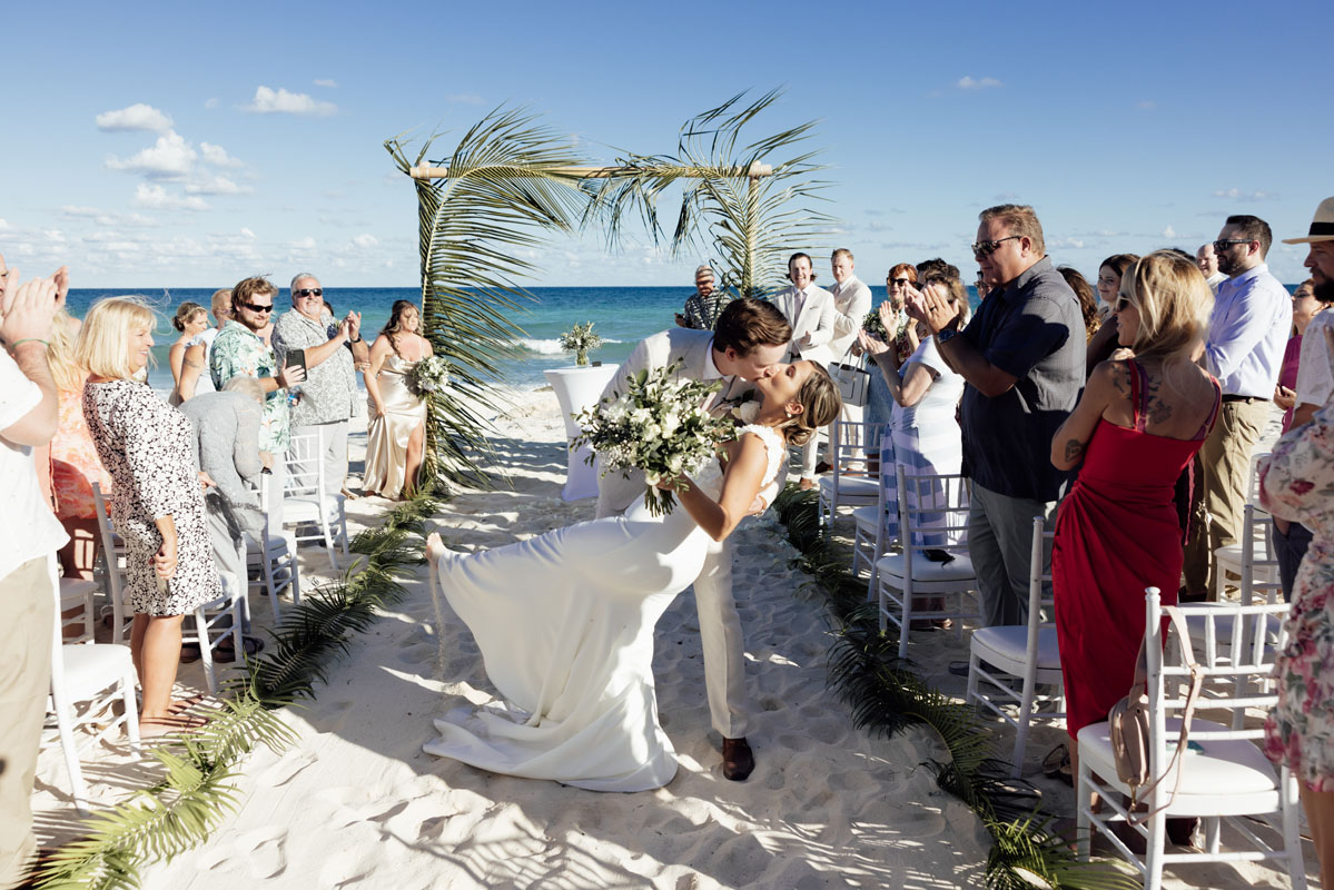 Newlyweds dip in a kiss after ceremony