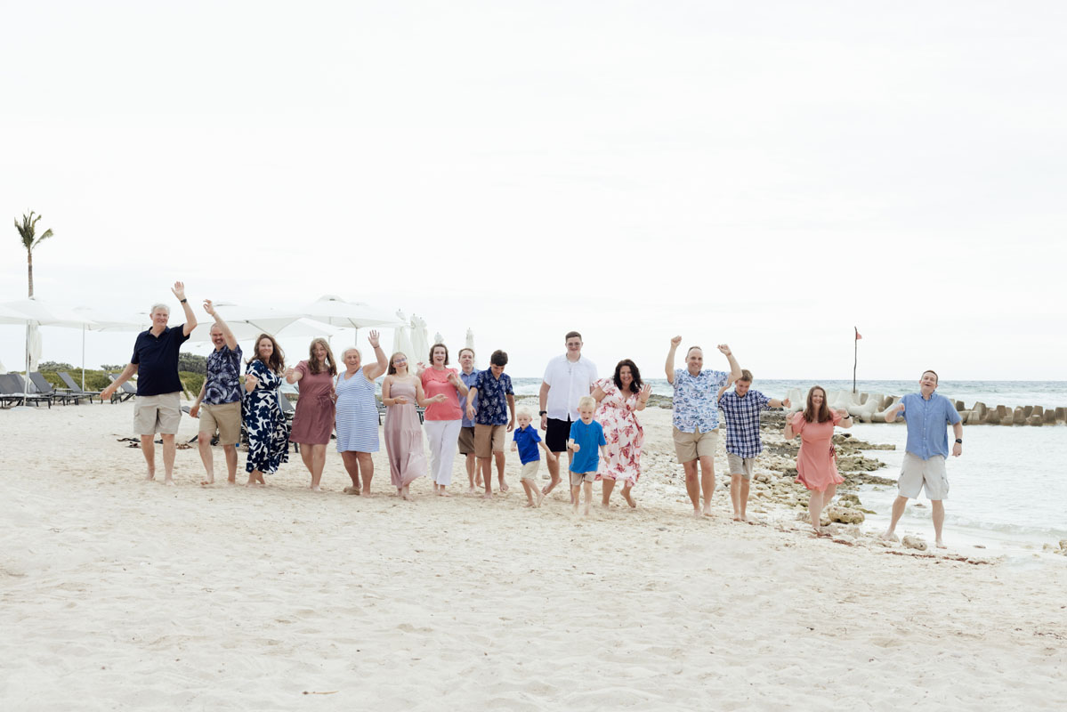 Cheering family enjoys a beach walk together