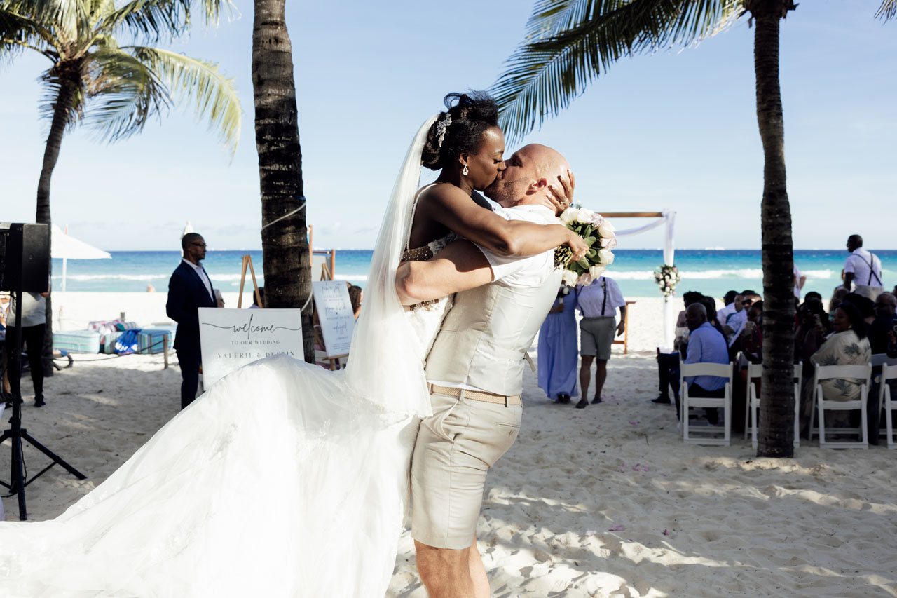 Newlyweds kiss as bride jumps into her grooms arms after ceremony