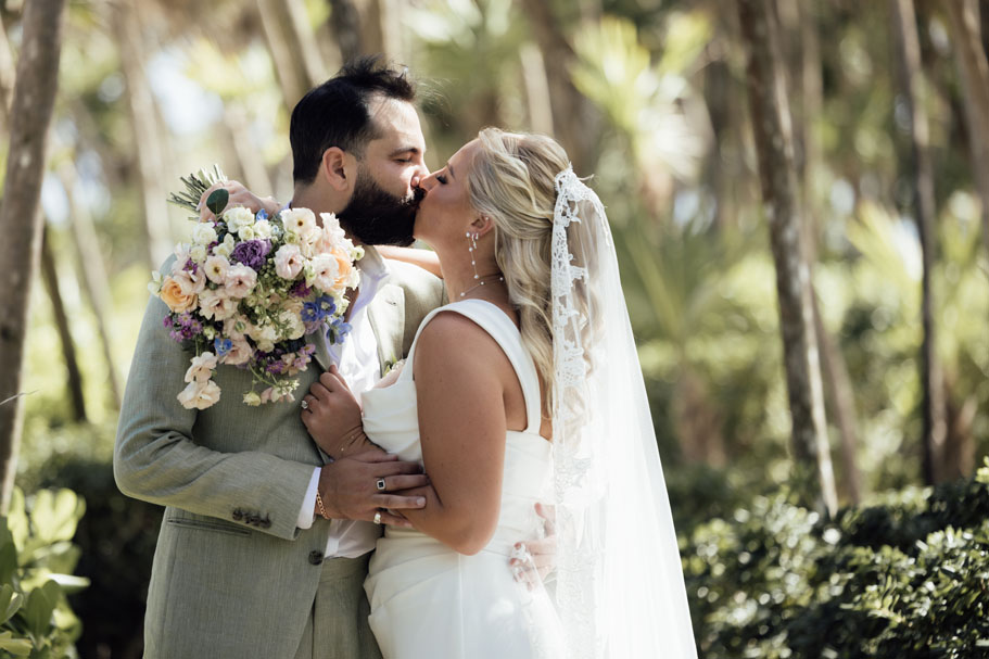 Wedding couple kiss after emotional first look